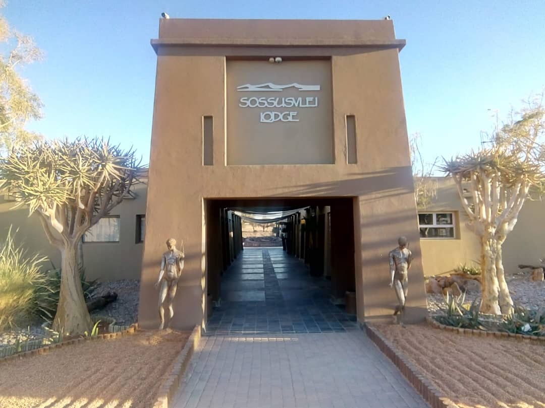 Sossusvlei Lodge entrance flanked by quiver trees